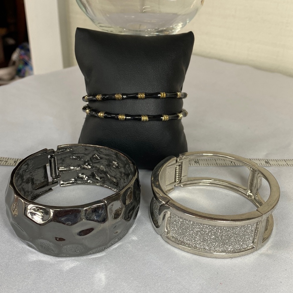 Group of 4 interesting black and silvertone bracelets